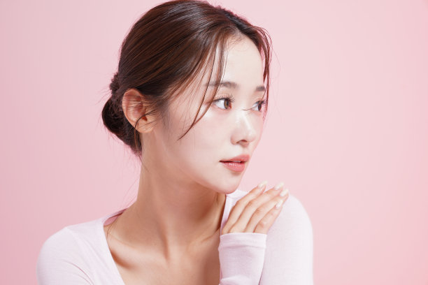 一个年轻女子在粉红色背景下拍摄的漂亮肖像图片下载