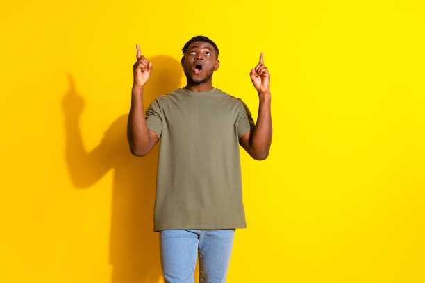 照片中开朗风趣帅气的好男人穿着卡其色的衣服哇新闻空白的空间孤立在黄色的背景图片下载