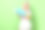 乐观的漂亮女孩的照片卷发穿条纹t恤拿着水枪在夏季聚会孤立的绿色背景图片下载