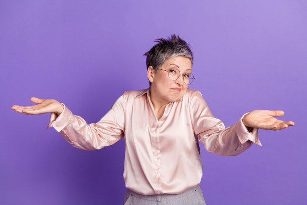 照片肖像可爱的高级夫人不知道耸肩穿着时尚的缎面服装孤立的紫罗兰色背景图片下载