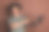 照片的年轻人在灰色t恤远程工作远程使用笔记本电脑指着显示器孤立的棕色背景图片下载