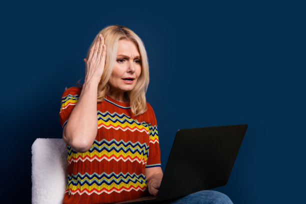 照片中焦虑紧张的可爱资深女性用户穿着条纹时尚服装的问题被隔离在深蓝色的背景上图片下载