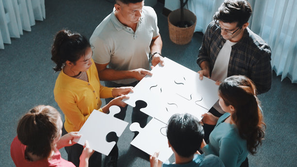 顶视图的聪明的商业人士把最后一块完成拼图。研讨会。图片下载