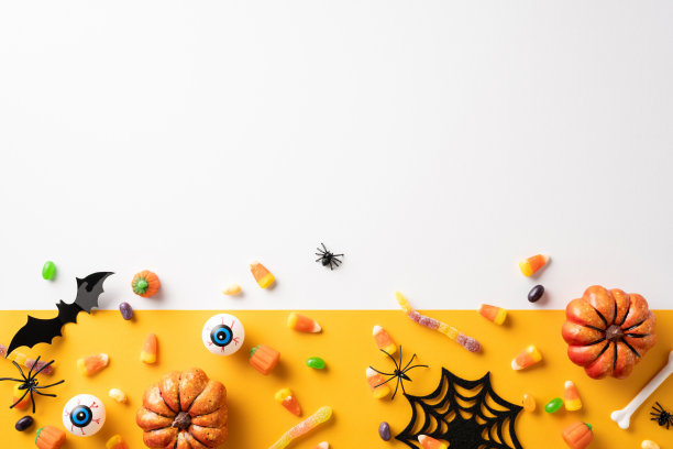 以万圣节为主题的图片，在充满活力的背景下，有各种各样的糖果、南瓜和幽灵般的装饰品，比如蝙蝠和蜘蛛图片下载