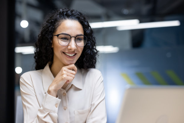 特写照片的年轻美丽的商业女性卷发和眼镜西班牙妇女谈论视频通话使用笔记本电脑进行远程通信和会议图片下载