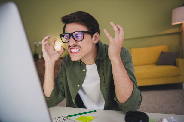 疯狂的企业家男人的照片坐在桌子工作从家里公寓工作场所工作空间晚上的灯在室内图片下载