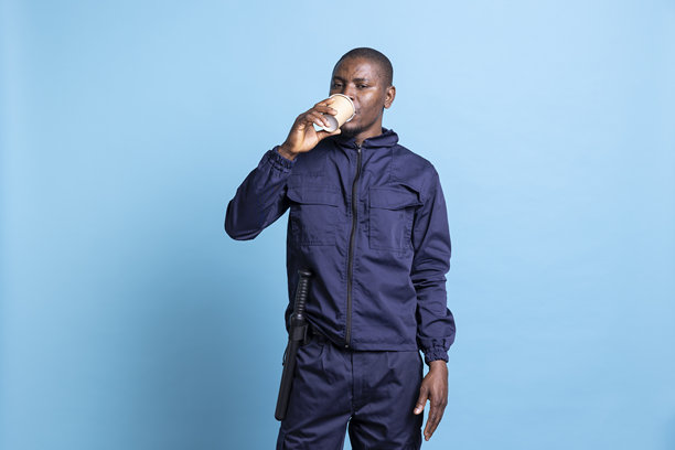 非裔美国安全人员在工作室喝咖啡的肖像图片下载