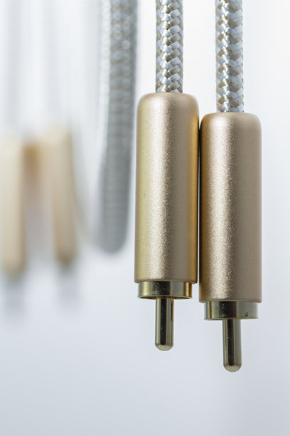 在白色背景下，金色外壳的辅助音频电缆的特写照片图片下载