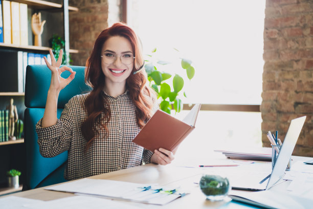 照片积极的好心情的女士专家穿着衬衫，显示好的说话耳机，麦克风现代设备在室内工作站车间图片下载