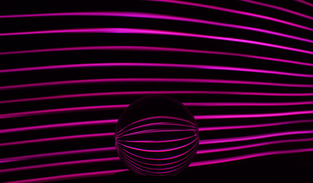 长时间曝光的照片。光画摄影-在玻璃球镜头后面的霓虹灯漩涡波。图片下载