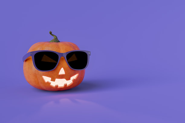 万圣节南瓜戴着紫色背景的太阳镜图片下载