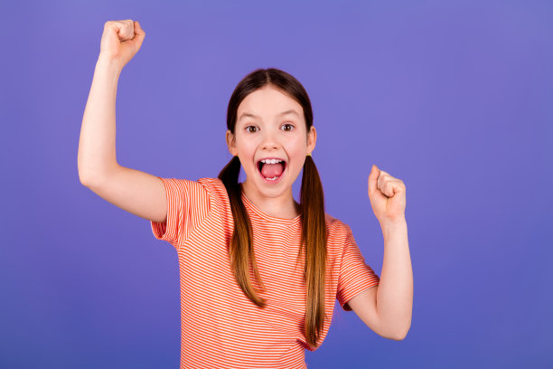 可爱小女孩的自拍照片，穿着时髦的红色衣服，在紫色的背景上亲吻图片下载