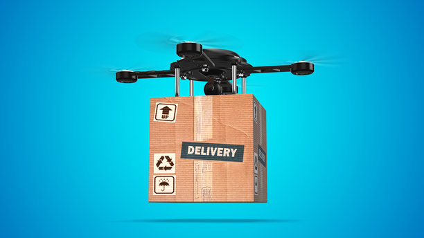无人机在蓝色背景下运送纸板包裹图片下载
