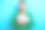 中年微笑的照片穿绿色时髦的套头衫男人深色的头发拿着很多现金钞票美元百万富翁孤立在蓝色的背景图片下载