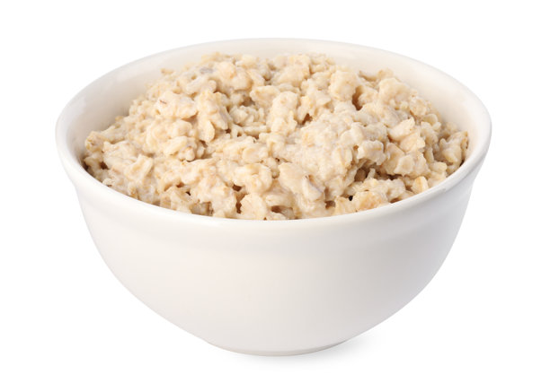 美味的煮燕麦粥盛在碗中，背景为白色。图片下载