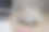 灰色桌子上的工作场所平铺，摆放着一杯咖啡、一台笔记本电脑和一本笔记本。教育、商业和办公室概念。图片下载