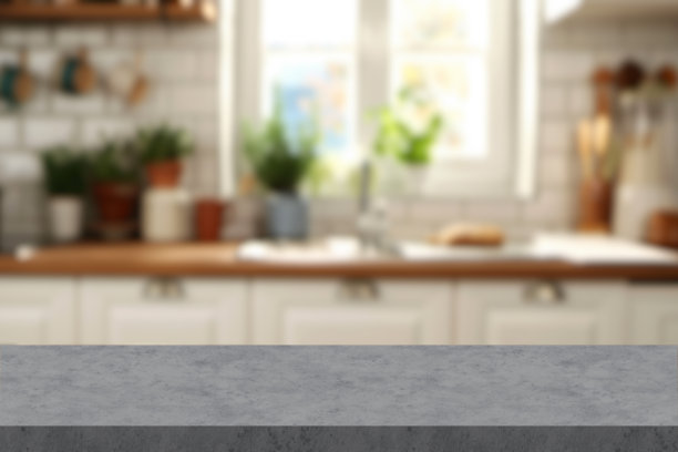 现代厨房岛的特写照片，石材大理石台面，背景模糊的厨房环境。图片下载