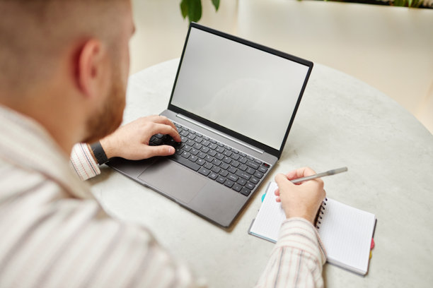 男人在咖啡馆的桌子上用笔记本电脑打字和写作图片下载