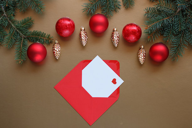 金色背景上的金红色圣诞装饰和圣诞卡片。图片下载