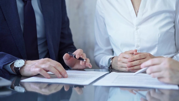多元化的商业人士在签署协议前讨论合同条款。律师和商界人士的团队合作图片下载
