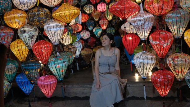 女孩在会安夜市享受夜晚的丝绸灯笼图片下载