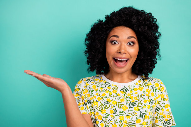 照片印象深刻的迷人的女士穿着印花t恤抱臂空空间孤立蓝绿色背景图片下载