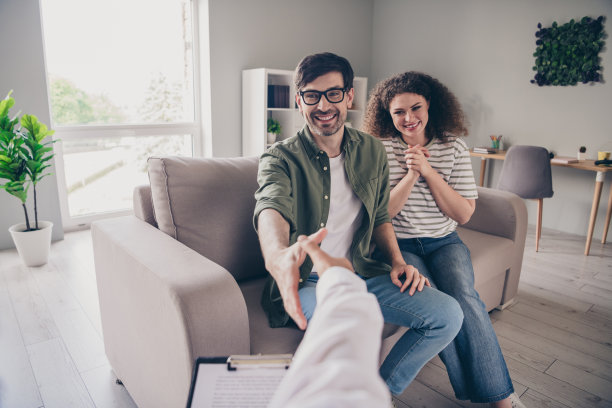 年轻夫妻在家中办公室与心理治疗师握手的第一人称视角照片图片下载