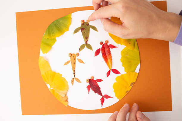 一个人手持一张上面有叶子的纸，过程艺术，锦鲤，圆形，色彩丰富的照片，微型产品照片。图片下载