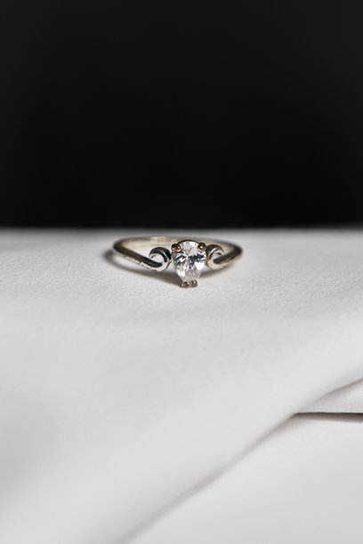 白色布料上的戒指照片，背景为黑色图片下载