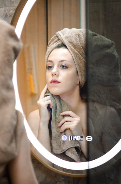 年轻女性裹着米色毛巾，头上盖着毛巾，正在清洁面部，为睡觉做准备 - 库存照片图片下载