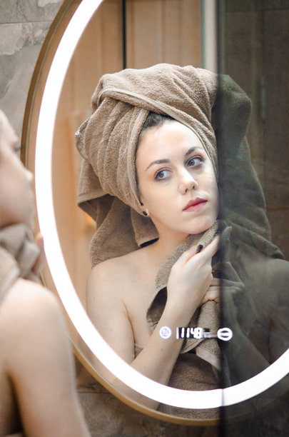 年轻女性裹着米色毛巾，头上盖着毛巾，正在清洁面部，为睡觉做准备 - 库存照片图片下载