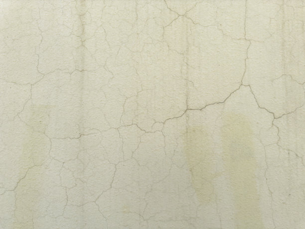 老旧的黄色墙壁，带有裂纹的灰泥纹理，库存照片图片下载