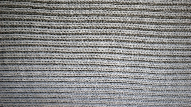 背景充满了灰色针织面料的纹理。照片。图片下载