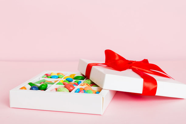 情人节构图：甜美的糖果，带有蝴蝶结的礼品盒和红色毛毡心形，照片模板，背景。透视视图，留有空白空间。图片下载