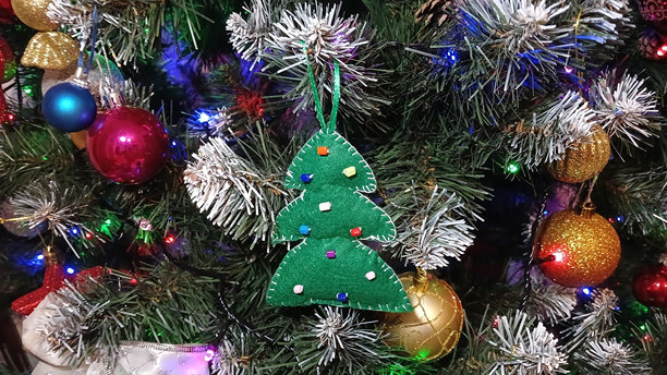 用毛毡制作的圣诞树，装饰着五彩缤纷的珠子，悬挂在圣诞树上，横向照片图片下载