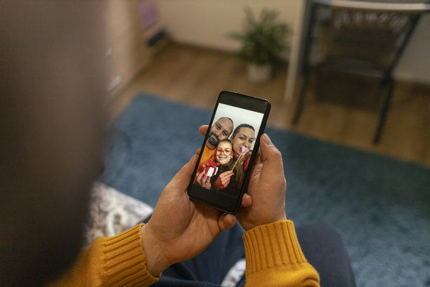 男人在手机上查看照片。情人节，家庭团聚。特写照片图片下载