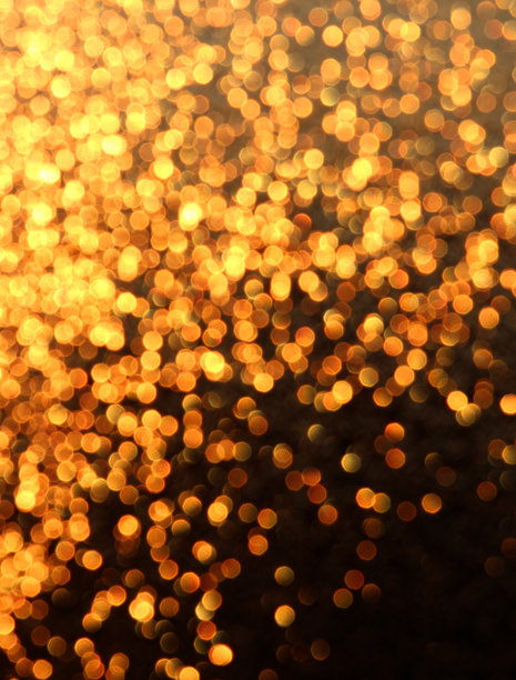 散景效果的照片，模糊的光点形成金色圆圈，背景有纹理。图片下载