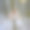 特写照片捕捉了霜冻覆盖的秋叶在树枝上的细腻美感。金棕色的叶子部分被雪和冰覆盖，与柔和模糊的冬季森林背景形成鲜明对比。图片下载