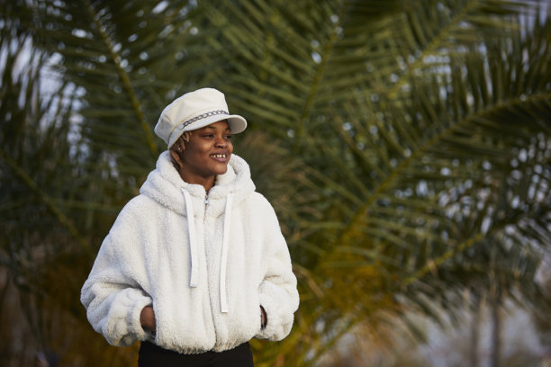 一组黑女性穿着白色时尚外套和帽子在公园的照片图片下载