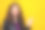特写照片，漂亮的卷发女士用手指指向空白处，穿着皮夹克，背景为黄色，表示低价。图片下载