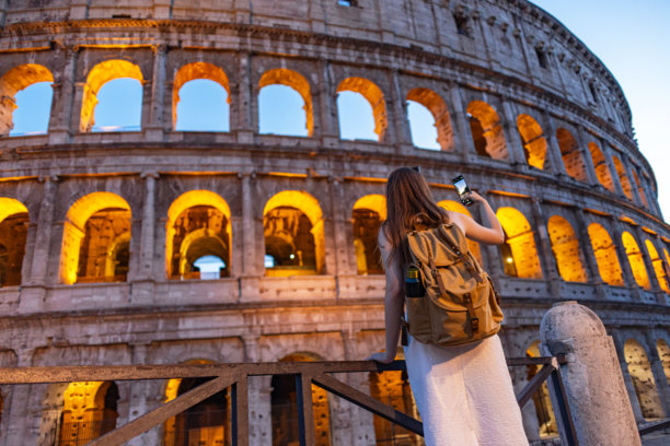 黄昏时分，一名女性背影在拍摄斗兽场的照片图片下载