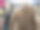 这张照片展示了商店里挂在衣架上的女性服装特写。焦点是一件棕色长袖连衣裙，胸部有开口设计。图片下载