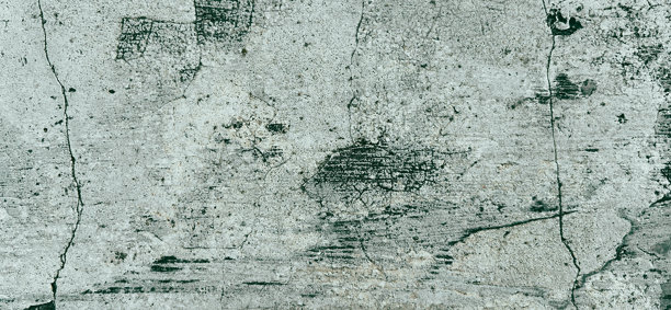 风化的灰色混凝土墙壁特写，带有裂缝和补丁。适合用作横幅背景或壁纸的优质经典墙面背景照片。图片下载