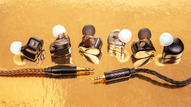 三对不同表面处理的耳塞特写，放置在光滑的金色表面上，非常适合展示科技配件和音频设备。高分辨率库存图片。图片下载