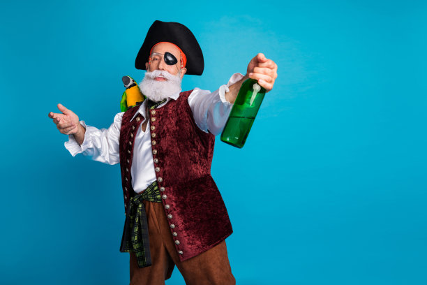 穿着复古服装的老海盗在蓝色背景下参加海洋冒险角色扮演派对嘉年华的照片图片下载