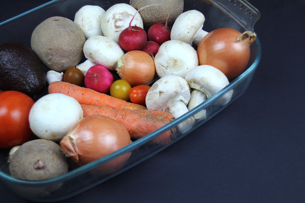 垂直照片，黑色背景上的玻璃容器装有蔬菜。图片下载