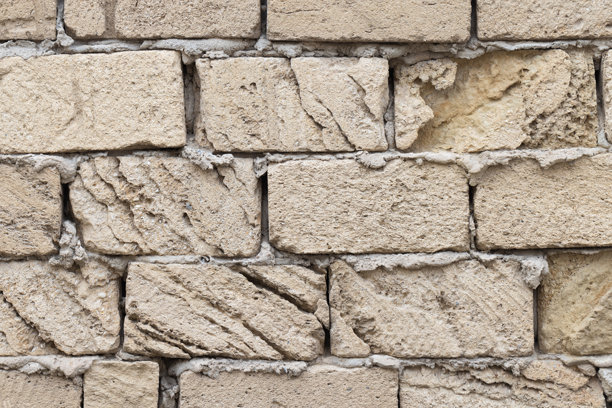 自然贝壳岩石砖墙的特写照片，背景纹理图片下载