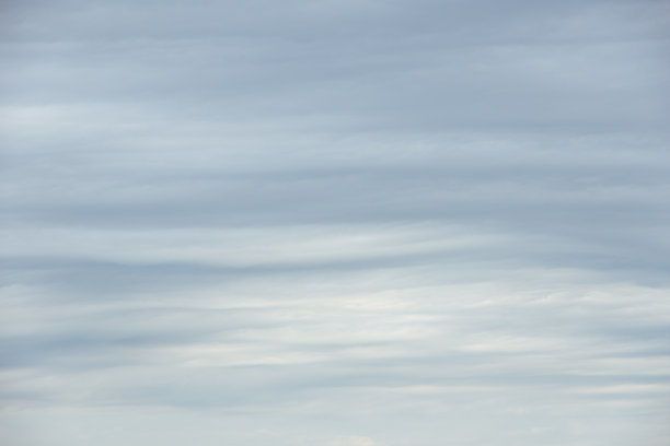 密集的灰色雷暴积云波浪状云层覆盖整个画面。阴沉的雨天天空背景，可用于叠加在您的照片上。图片下载