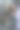 女性在光滑的浴室镜子前用吹风机吹干头发，体现了现代家庭环境中日常生活和个人护理的本质。竖版照片图片下载
