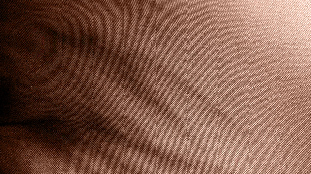 纹理布料的照片。植物投下的阴影。摩卡慕斯。不同颜色的阴影。图片下载